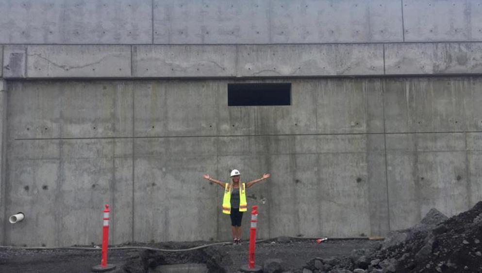 Calley visited the wall during early construction to get a picture of what it might be like to create a mural to cover the length of a football field.
